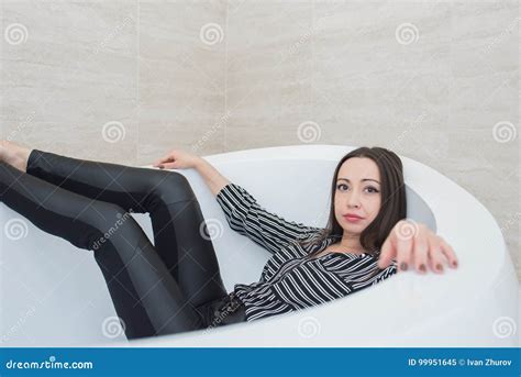 The Brunette Girl Lies In A Bathtub With A Calm And Peaceful Expression Stock Image Image Of
