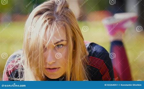 Attractive Female Blonde Bikini Fitness Model Stretching In The Autumn Park On Ground Covered