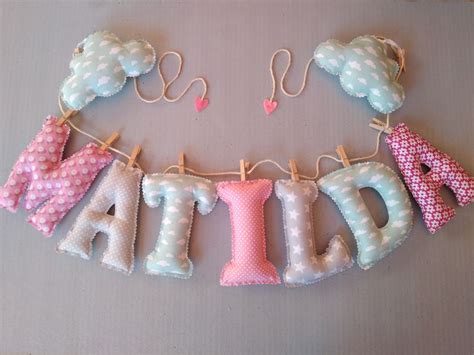 The Letters Are Made Out Of Fabric And Hanging On Clothes Pins