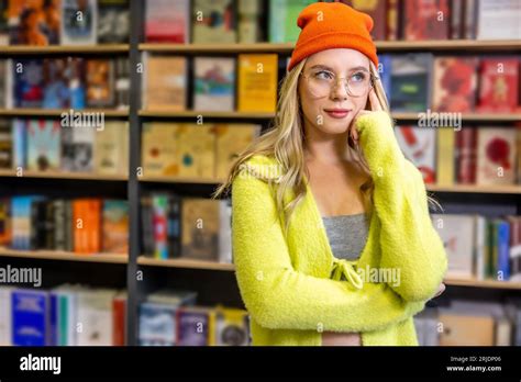 Cute Blonde Woman Standing In The Library Stock Photo Alamy