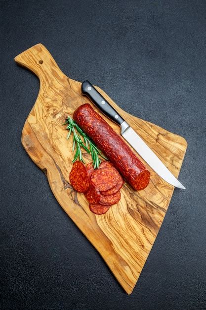 Premium Photo Dried Organic Salami Sausage On Wooden Cutting Board