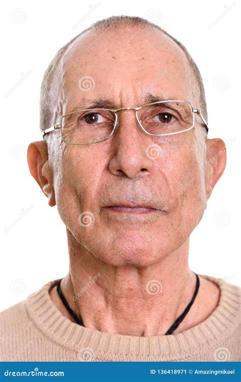 Face Of Senior Man Wearing Eyeglasses Isolated Against White Background