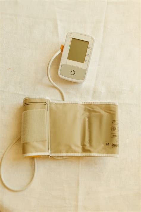 Digital Blood Pressure Monitor and Pressure Cuff on White Fabric · Free ...