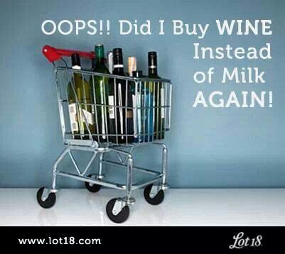 A Shopping Cart Filled With Lots Of Wine Bottles And Liquor In Front Of