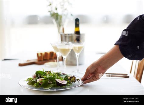 Womans Hands Serving Salad On Set Table Stock Photo Alamy