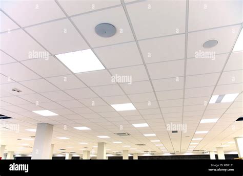 Modern design white office ceiling with white tiles and lighting Stock Photo - Alamy