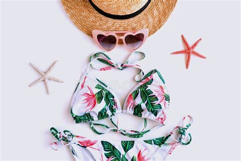 Flat Lay Of Summer Item With Colorful Bikini Beach Hat Coral In Starfish Shape And Pink