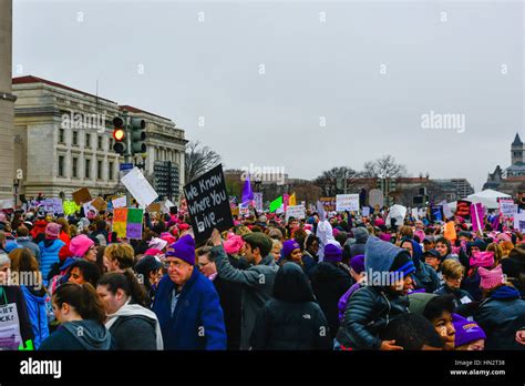 Large Crowd Of Protesters Holding Signs And Wearing Pink Pussy Hats Flood The In Washington Dc