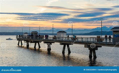 People Take A Late Winter Evening Walk On The Fishing Pier At Edmonds