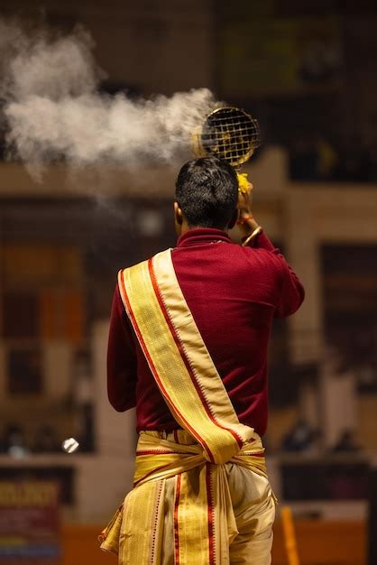 Premium Photo | Ganga aarti portrait of young priest performing holy ...