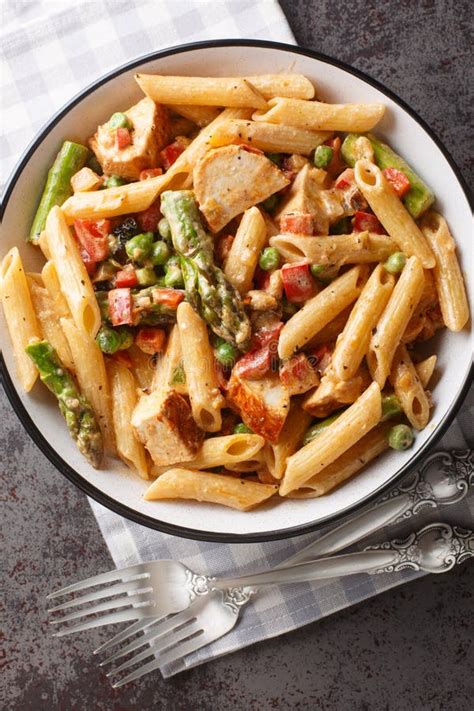 Penne Pasta With Chicken Asparagus Bell Peppers And Green Peas In A Creamy Chipotle Cheese