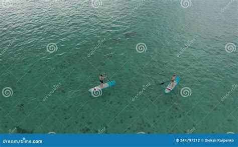 Surfers Couple On Surfing Board Man And Woman Swimmers Relaxing On