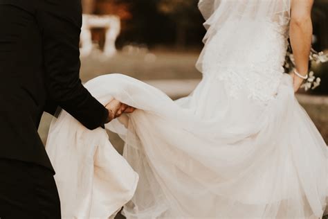 Man Helping Bride With Her Wedding Dress Photo Free Wedding Image On