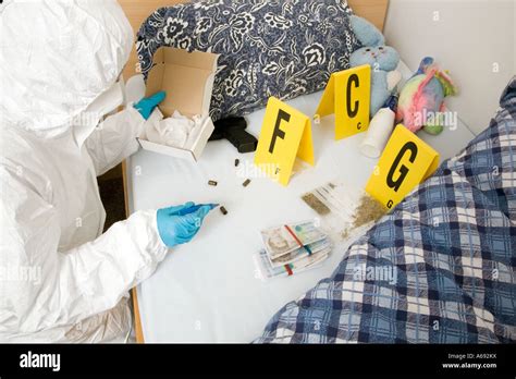 Forensic Officer Collecting Evidence In Drug Dealers Room Stock Photo