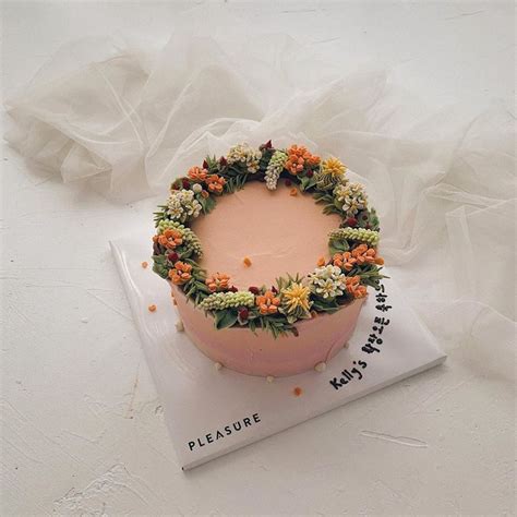 There Is A Cake With Flowers On Top Of The Book And It Says Please Write