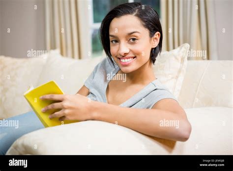 Smiling Brunette Reading Book Stock Photo Alamy
