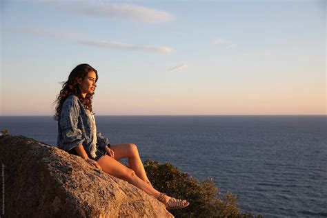 Beautiful Brunette Looking At Sunset On The Sea By Stocksy Contributor Michela Ravasio Stocksy
