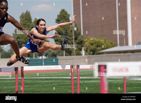 female athletes hurdling stock photo alamy