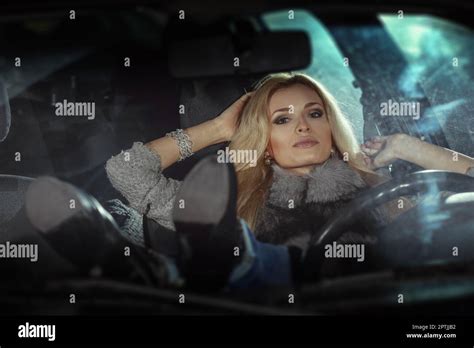 City Portrait Of Pretty Blonde Driver Inside The Car Night Scene Lady Behind The Wheel Stock