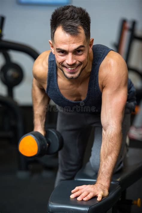 Hombre Feliz Haciendo Ejercicio Con Dumbbell En El Gimnasio Foto De