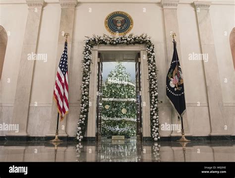 Holiday decorations are seen in the cross hall of the White House in ...