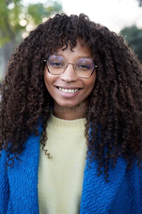 Vertical Portrait Of Smiling Young African Woman With Curly Hair