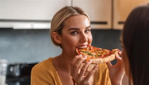 Women Eating Pepperoni Pizza Slice Premium Ai Generated Image