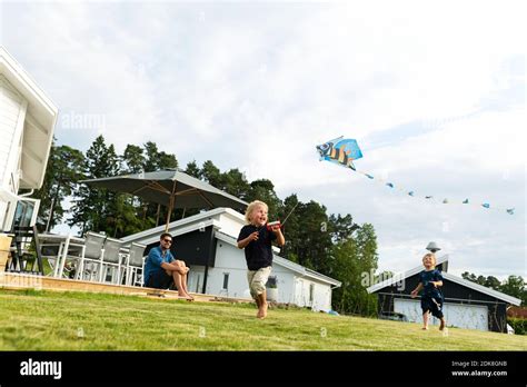 Children flying kite Stock Photo - Alamy