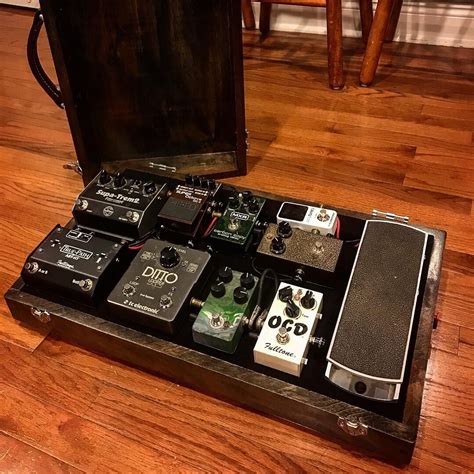 An Assortment Of Pedals In A Case On The Floor