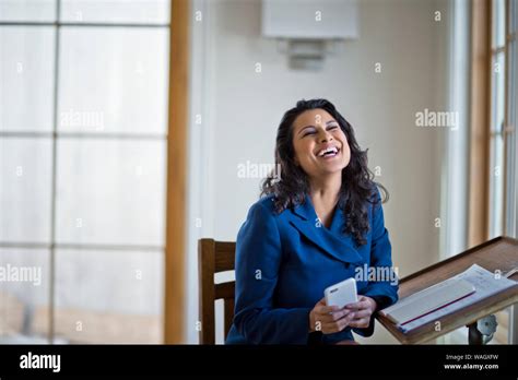 Woman Holding Cell Phone And Smiling Stock Photo Alamy