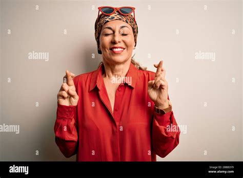 Middle Age Brunette Woman Wearing Handkerchief On Head And Shirt Over