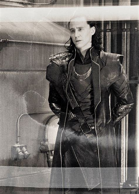 A Black And White Photo Of A Man Wearing A Leather Outfit With Words Written On It