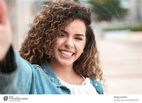 Young Latin Woman Taking Selfies Outdoors On The Street A Royalty