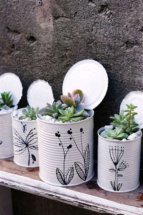 Four Tin Can Planters With Succulents On Them