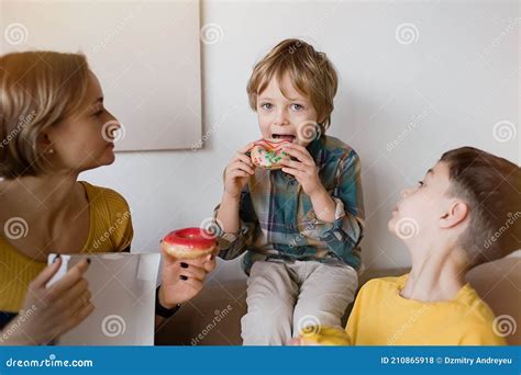 Cute Boy Is Eating Donut Stock Photo Image Of Delicious 210865918