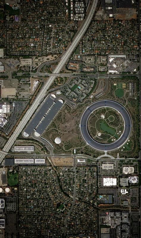 an aerial view of a highway and parking lot in the middle of a large city