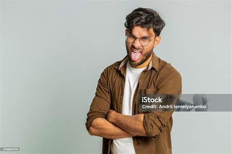 Cheerful Funny Bully Indian Man Showing Tongue Making Silly Faces