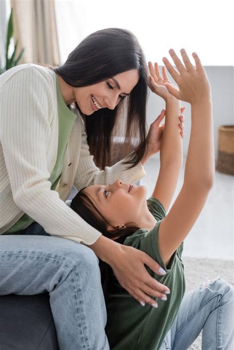 Happy Brunette Babysitter Sitting On Couch Stock Image Image Of Happy Brunette