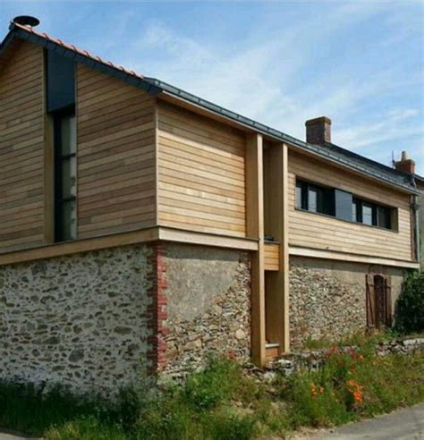 An Old Stone And Wood Building On The Side Of A Road