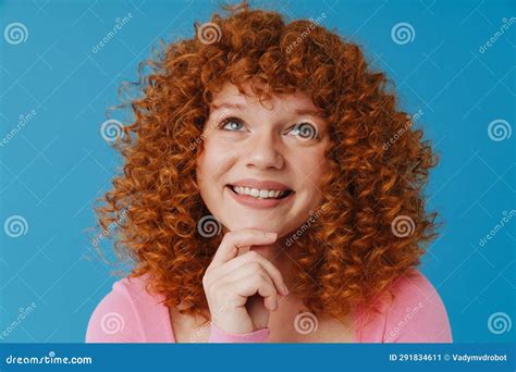 European Woman With Red Curly Hair Smiling And Looking Upward Stock