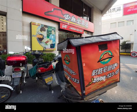 Delivery motorcycle outside a Pizza Hut restaurant in Shanghai, China ...