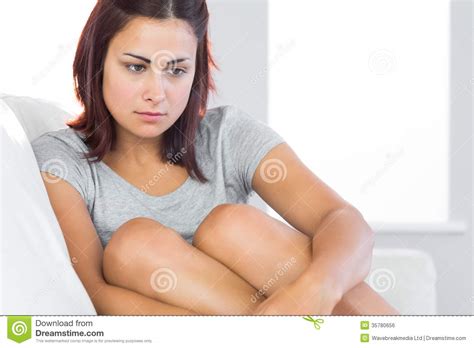 Thoughtful Brunette Woman Sitting On Her Couch Stock Photo Image Of