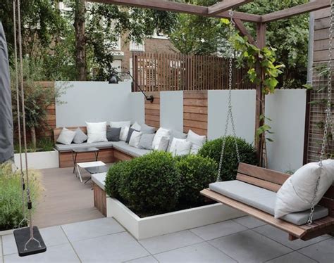 A Wooden Bench Sitting On Top Of A White Tiled Floor Next To A Garden Area