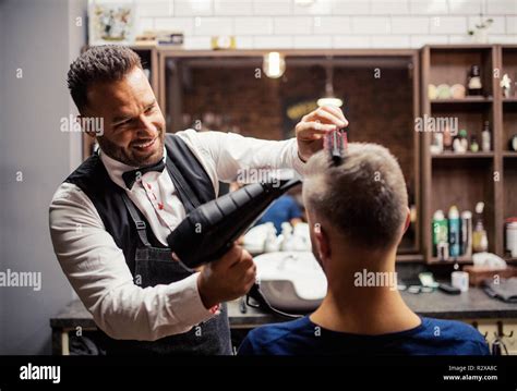 Hipster Man Client Visiting Haidresser And Hairstylist In Barber Shop