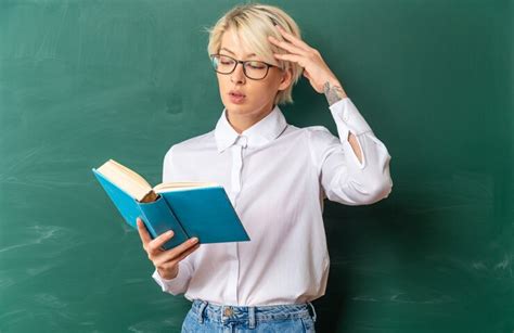 Free Photo Confused Young Blonde Female Teacher Wearing Glasses In