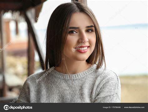 Beautiful smiling woman outdoors Stock Photo by ©belchonock 179788496