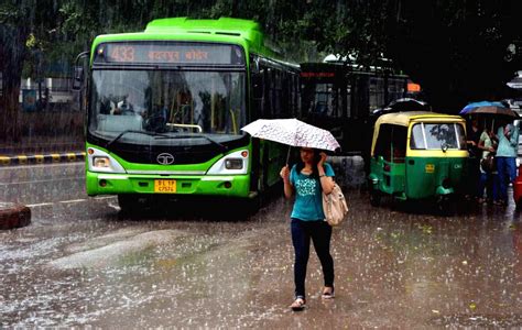 Commuters Travel During Rain In Delhi