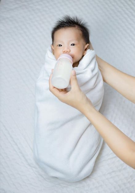 Premium Photo Mother Feeding Baby With Milk Bottle