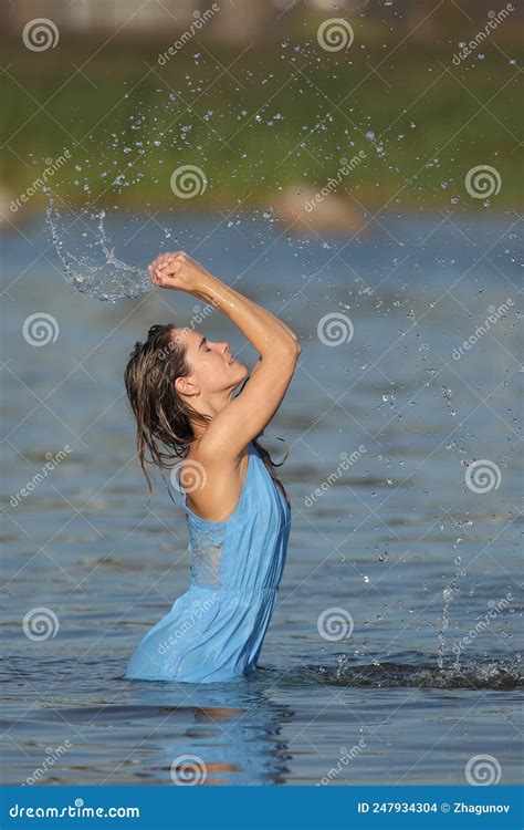 Young Woman in the Water in a Dress Stock Photo - Image of attractive ...