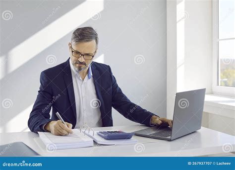 Mature Businessman Working At Laptop Computer In Office Stock Image